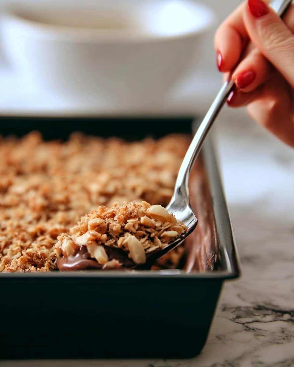 A sandwich with a shiny, golden brown sesame seed top bun, soft and slightly wrinkled on top. Underneath is a thick layer of shredded, dark brown pulled meat mixed with chunks, drenched in a glossy, dark barbecue sauce. Melted yellow cheddar cheese drips slightly over the meat. The bottom bun is pale, light golden, and soft with a slightly toasted texture. The sandwich sits on a white plate placed on a white marbled surface. photo taken with an iphone --ar 4:5 --v 7
