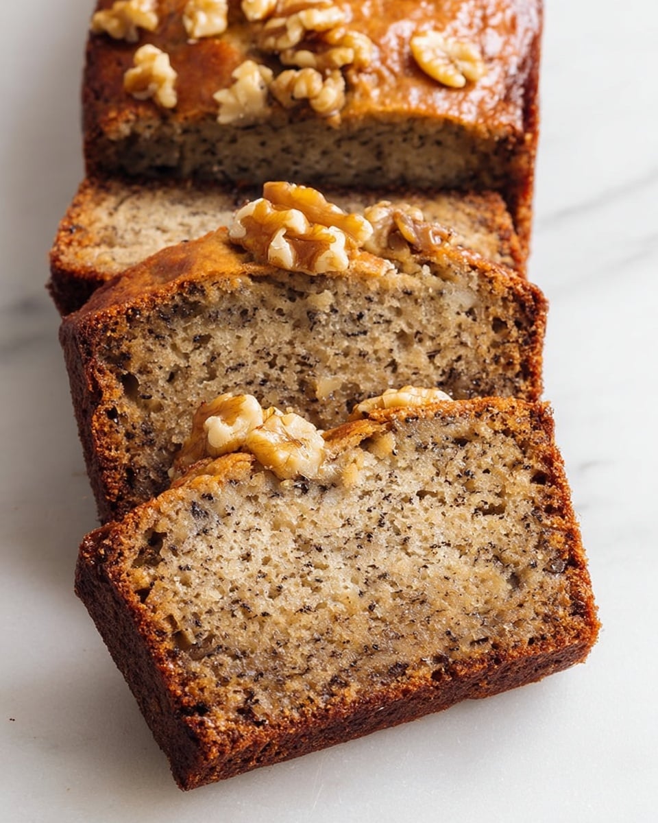 The image shows four slices of banana nut bread placed on a white marbled surface. Each slice has a golden-brown crust with visible walnut pieces embedded throughout the moist, light brown interior. The nuts inside the bread add texture and contrast with darker brown spots against the softer, speckled banana bread. The top crust has a slightly glossy appearance with chunks of walnuts scattered on top, enhancing the rustic look of the bread. The slices are stacked in a slightly overlapping way, giving a clear view of the dense, nutty texture inside. Photo taken with an iphone --ar 4:5 --v 7