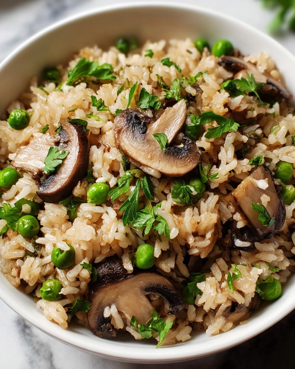 A close-up of a white bowl filled with cooked rice mixed with sliced brown mushrooms and bright green peas, scattered with fresh green parsley leaves on top, showing a mix of soft, tender textures and vibrant colors. The rice grains appear fluffy and slightly brownish, with mushroom slices that have a smooth, slightly shiny surface, and peas that look fresh and firm. The bowl sits on a white marbled surface, creating a clean and simple background. photo taken with an iphone --ar 4:5 --v 7