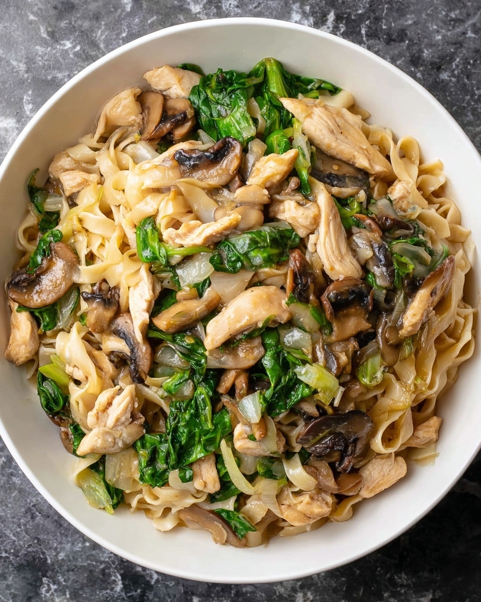 A white bowl filled with a stir-fry dish featuring several layers: at the bottom, pale yellow flat noodles; scattered throughout are light brown strips of cooked chicken; dark brown sliced mushrooms add texture and richness; bright green leafy vegetables, slightly wilted, are mixed in; translucent cooked onions are spread all over, adding softness; the dish is coated in a light, glossy sauce that ties the ingredients together. The bowl is placed on a white marbled surface. Photo taken with an iphone --ar 4:5 --v 7