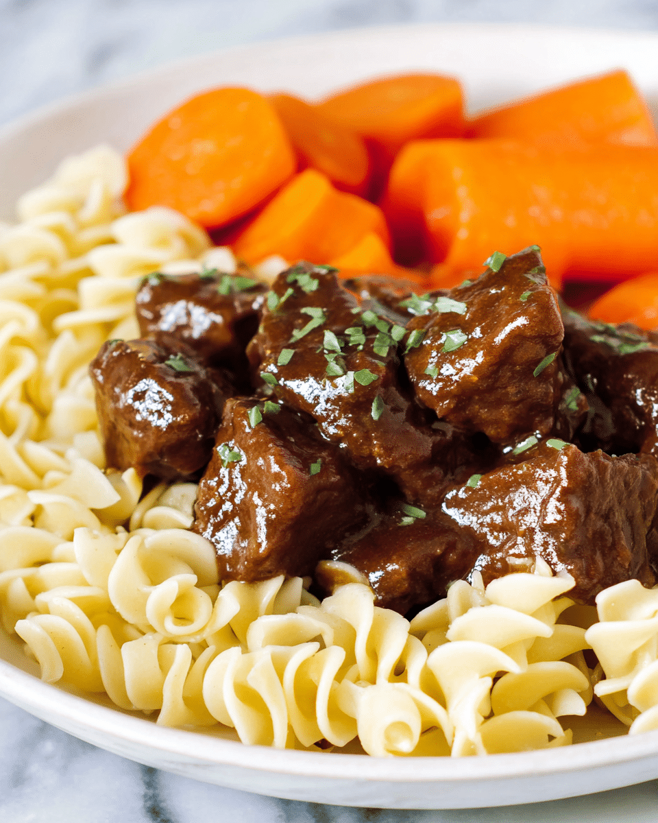 A white plate with three main layers: the bottom layer is light yellow egg noodles with a soft and slightly curled texture; on top of the noodles are glossy, dark brown beef chunks covered in a shiny gravy with small green herb bits sprinkled over; behind the beef are several thick, bright orange carrot slices with a soft texture. The plate is on a white marbled surface. photo taken with an iphone --ar 4:5 --v 7